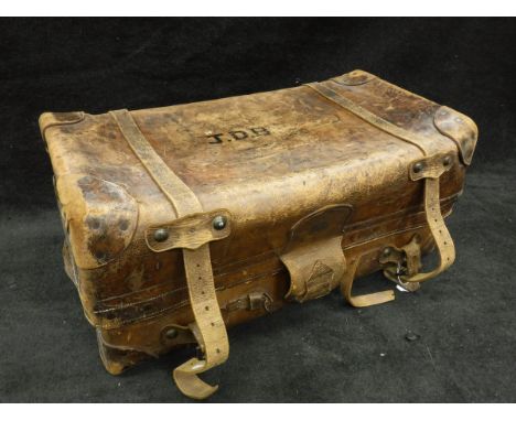 A vintage leather trunk inscribed "JWB" to top