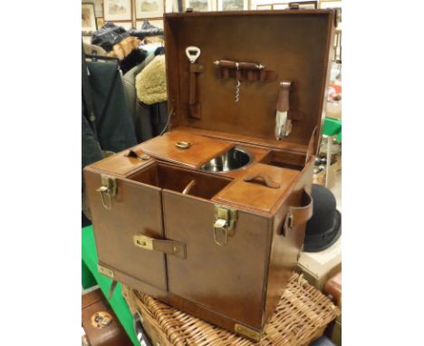 A leather drinks' case, the hinged lid opening to reveal a fitted interior to include ice bucket and bar tools