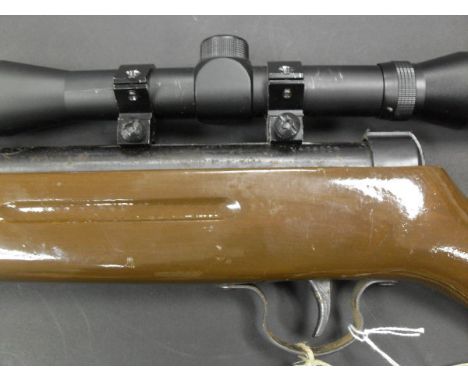 A Snowpeak .22 air rifle with 4 x 32 telescopic sight and 2 ammunition belts