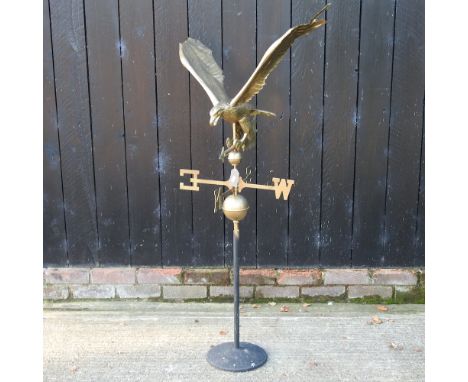 A gilt painted metal weather vane, in the form of an eagle, on stand, 142cm high overall
