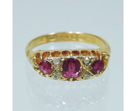 A 18 carat gold ruby and diamond ring, boxed