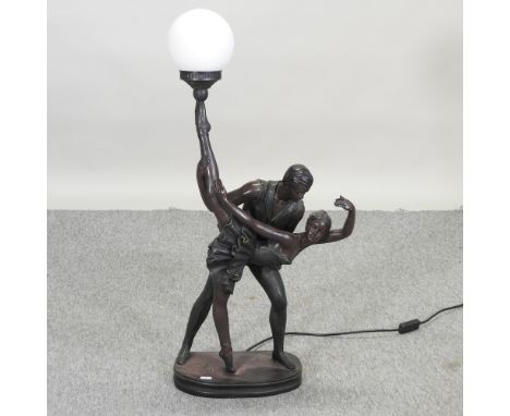 A bronzed figural table lamp, in the form of a couple dancing, with an opaque glass globe shade, 82cm high