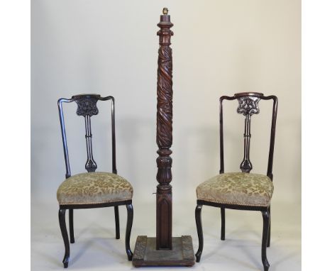 A pair of Edwardian side chairs, with green padded seats, together with a carved wooded standard lamp