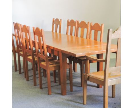 A light oak dining table, with two additional leaves, 280 x 90cm overall, together with a set of nine rush seated dining chai