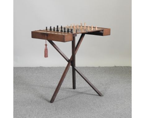 An early 20th century folding chess table, 70 x 48cm, together with a chess set