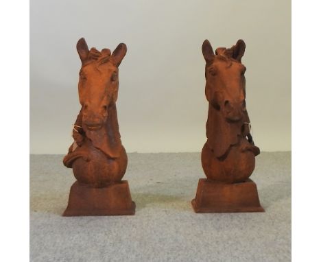 A rusted horse head finial, together with another, 46cm high