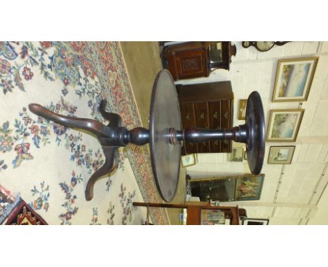 A George III mahogany two-tier circular dumb waiter on turned column and tripod support, 57cm diameter, 85cm high.