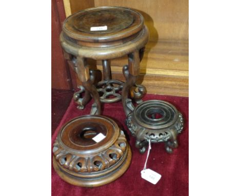 A Chinese carved hardwood jardinière stand, the circular burr wood top, 20cm diameter, on five carved scroll legs joined by a