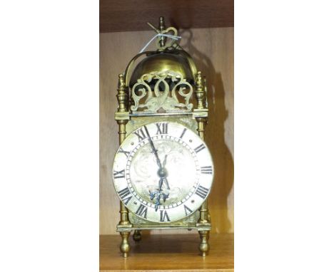 A 20th century brass lantern clock of typical form with French movement, 25cm high.