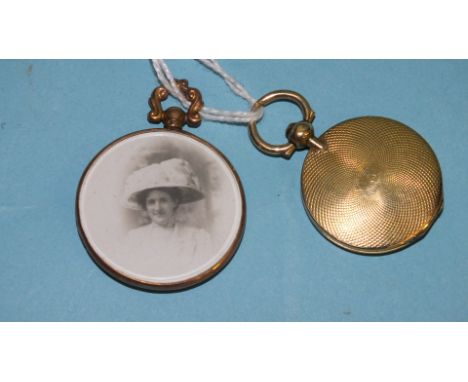 A gold-mounted double-sided locket and an engine-turned locket, (glass missing), (2).