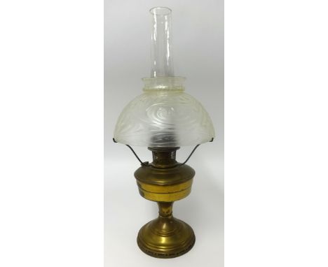 An early 20th Century gilt framed and convex mirror, together with an Aladdin model 12 oil lamp with glass shade (2).