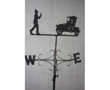 A painted black cast iron weather vane and pole with a farmer and tractor and points of the compass.&nbsp;H.83 Diam. 66cm Pol