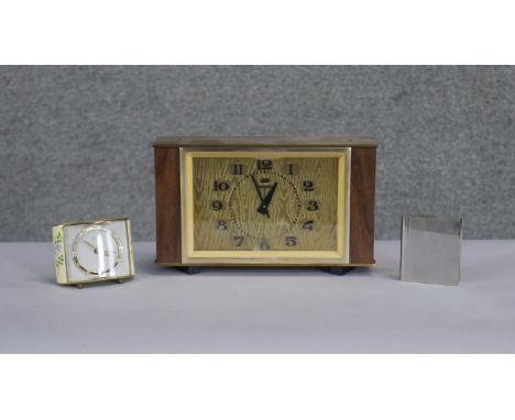 Three vintage clocks. Including a Vega brass and teak Art Deco mantle clock, a chrome book clock and a small floral design cl