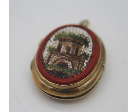 A 14 carat gold locket with engraved vase of flowers to the back and micro mosaic panel to the front depicting a Classical ru