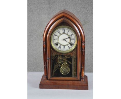 A late 19th century mahogany eight day cathedral mantle clock by Waterbury Corinth, USA. The glass plate gilded with a wheat 