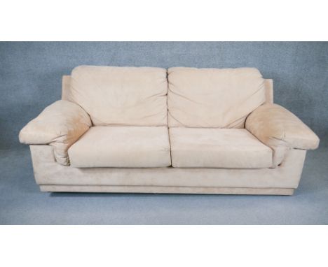 A contemporary two seat sofa in faux suede upholstery. H. 90 W. 205 D. 100 