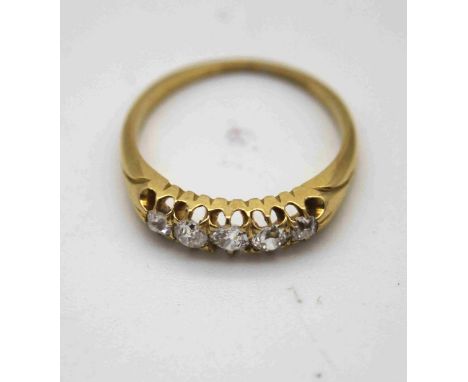 A Victorian 18 carat yellow gold five stone old cut diamond carved half hoop ring. Set with five cushion shaped old cut diamo