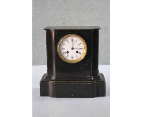 A late 19th century Continental ebonised mantle clock with eight day movement and white enamel dial with black Roman numerals