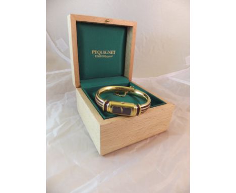 A ladies Pequignet wristwatch in yellow metal and red enamel, the back inscribed "3513", housed in a wooden case