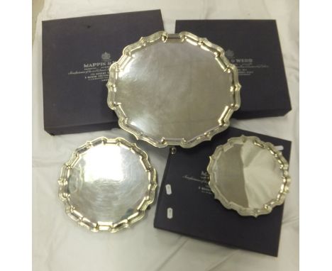 A box containing a graduated set of three silver plated salvers by Mappin & Webb Sheffield, a pair of Dolland Imperial 8 x 30