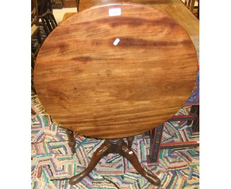 A 19th Century mahogany tea table, the circular snap top on a turned pedestal to cabriole tripod base