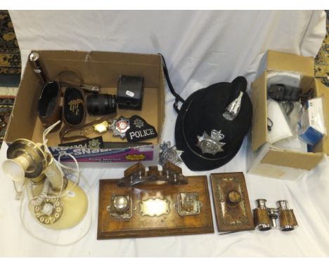 A box of miscellaneous items to include a policeman's helmet, various police badges, an Ingersol pocket watch, an Eastern inl