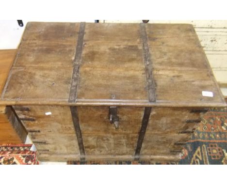 An Indian teak and iron bound trunk with iron handles, on plinth base