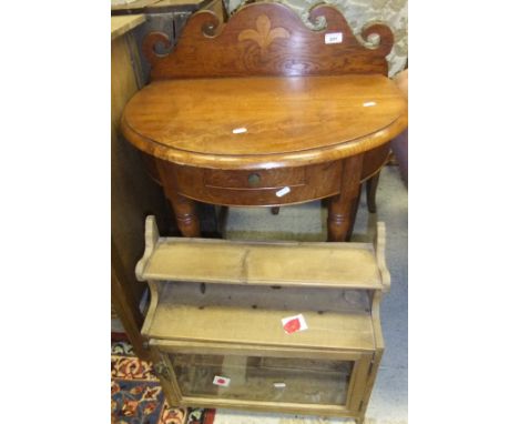 A modern teak demi-lune side table in the 19th Century manner, together with a circa 1900 pine wall shelf with glazed single 