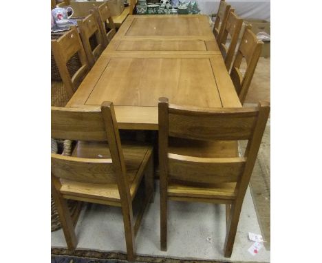 An oak rectangular extending dining table, together with eight ladder back dining chairs