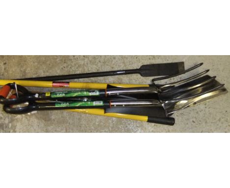 A fork, a spade, a post hole digger, post hole spade and a root chopper *