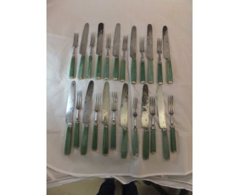 A set of twelve 19th Century stained green ivory handled knives and forks with white metal mounts, ten of the knife blades st