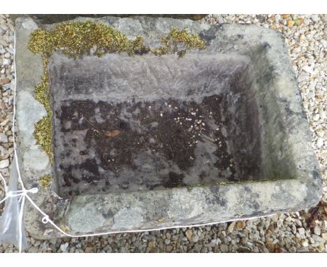 A natural stone rectangular trough