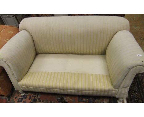 A circa 1900 scroll arm drop end sofa, upholstered in yellow striped fabric