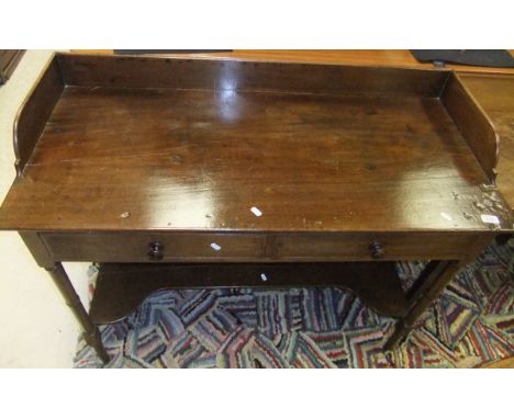 A Victorian mahogany washstand, the three quarter galleried top above two frieze drawers on turned and ringed supports united