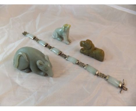 A carved jade figure of a rat, together with two further stylised dog figures and a jade and white metal mounted bracelet