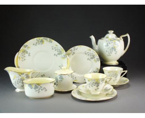 A good Royal Doulton Art Deco teaset dated 1933 of the Fairey shape and decorated with stylised prunus flowers and foliage in