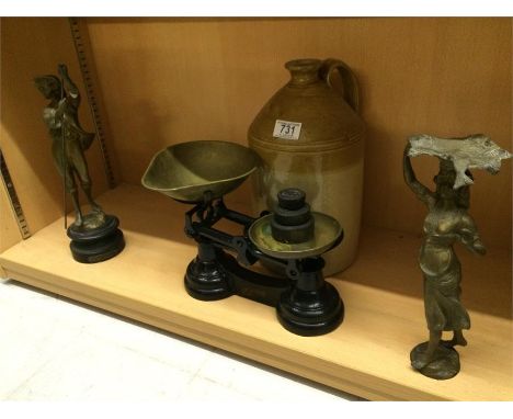 A stoneware bottle, set of scales and two spelter figures