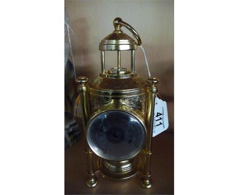 A brass clock with built in barometer and compass etc.