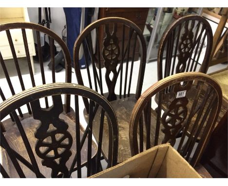 A set of four wheelback chairs and a similar stick back chair