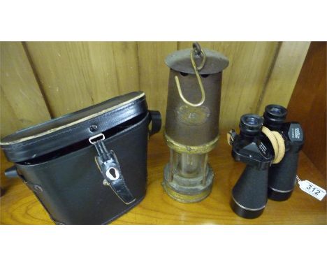 A pair of Prinz Micro binoculars 12 x 50, one other pair along with a miners lamp