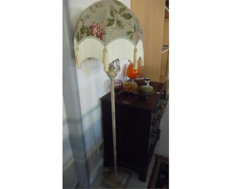 An elegant cream standard lamp with glass drops