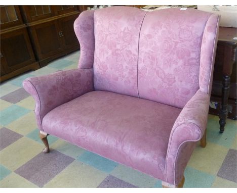 A wingback 2 seater sofa on cabriole legs