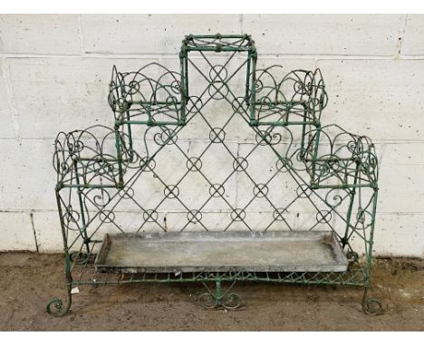 A 1920's metal wire work garden planter stand with original green paint finish, 102cms wide x 26cms deep x 80cms high. Estima