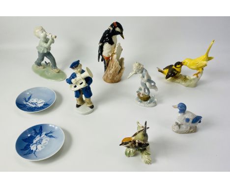 A collection of porcelain items to include Goebel bird figurines and Royal Copenhagen saucers,along with others. 18.5cms high