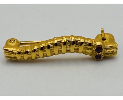 WWII gold Caterpillar Club pin with ruby eyes, engraved to reverse SGT RJW Brown, approximately 1.8cm long. Estimate £350-400