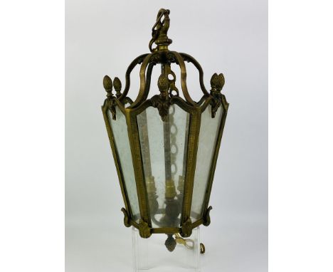 An decorative tapered hexagonal brass and glass hanging lantern, complete with ceiling boss mount, 47cms high x 25cms wide x 