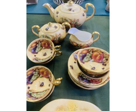 An Aynsley Orchard Gold with backstamps to the underside part tea service; teapot, jug, sugar bowl, cups, saucers and a shape