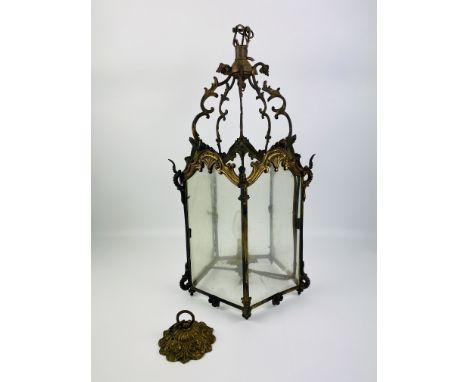 A decorative Rococo style five sided brass and glass hanging lantern, complete with ceiling boss mount, 57cms high x 29cms wi