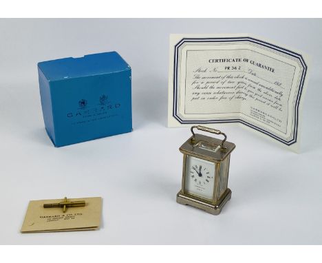 A boxed "Garrard &amp; Co,London W1" miniature carriage clock,with eleven jewels,bevelled glass panels and a Roman numeral di