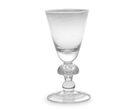 A rare mushroom-knopped heavy baluster goblet, circa 1710-20The generous round funnel bowl with a solid base, set on a wide t